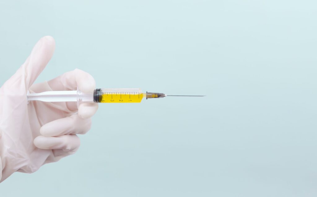 hand holding needles or syringe