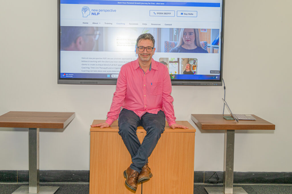 Rod sitting on desk at front of classroom
