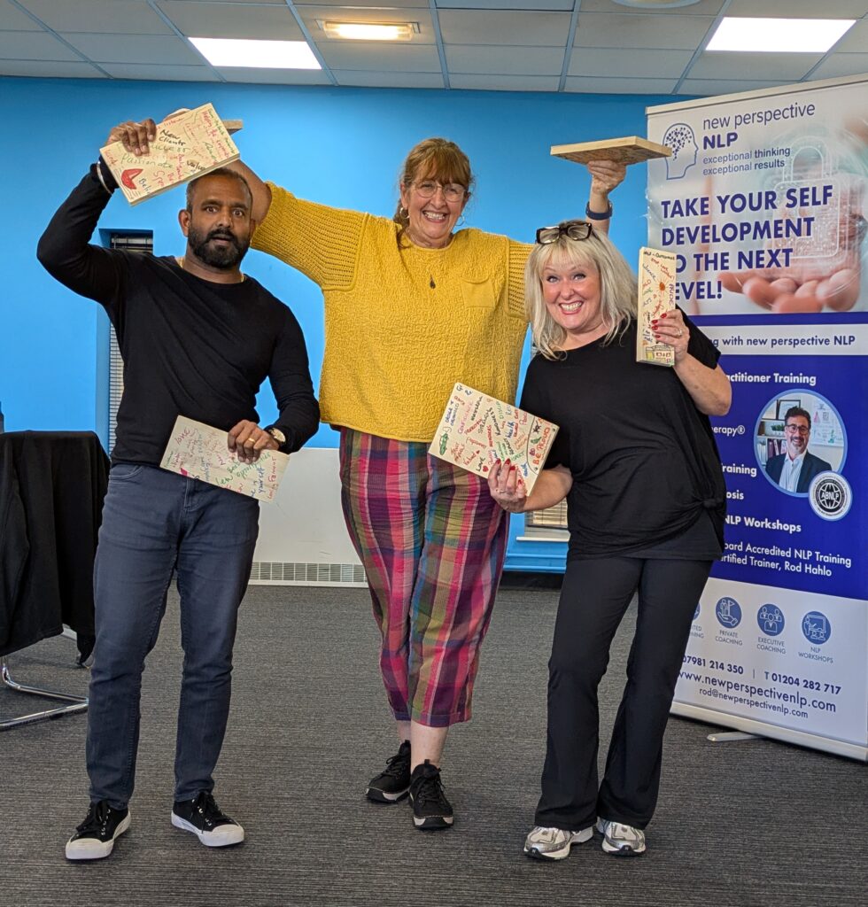 Group of NLP master practitioner students after board break