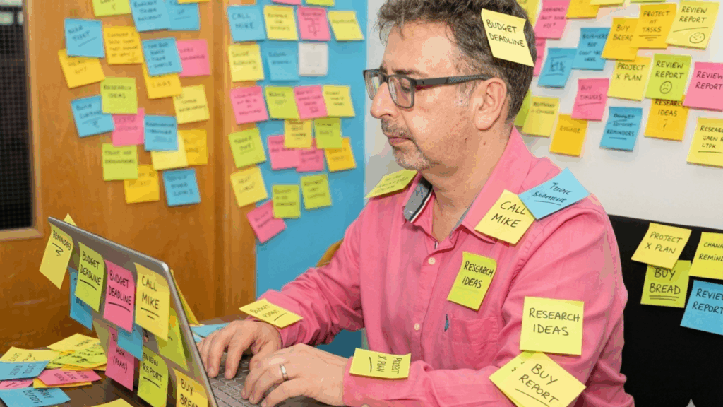Rod typing on laptop covered in post it notes, too many open tabs